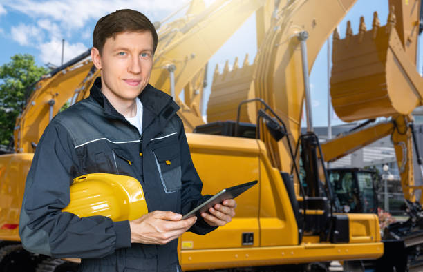 istock Engineer with a digital tablet on the background of construction machines 1414811153