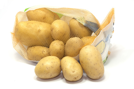 yellow pasta potato tuber with red net bag