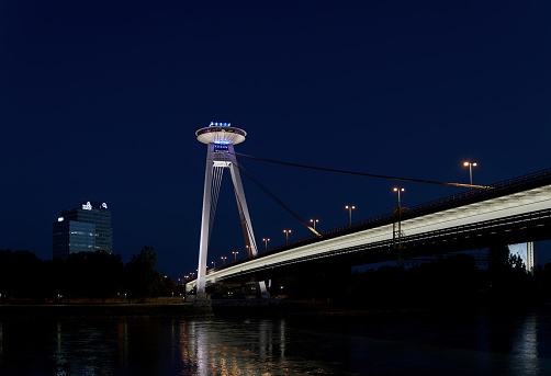 Bratislava, Slovakia – June 19, 2022: The bridge of the Slovak National Uprising in Bratislava SNP over the Danube River in the evening with a restaurant at a great height