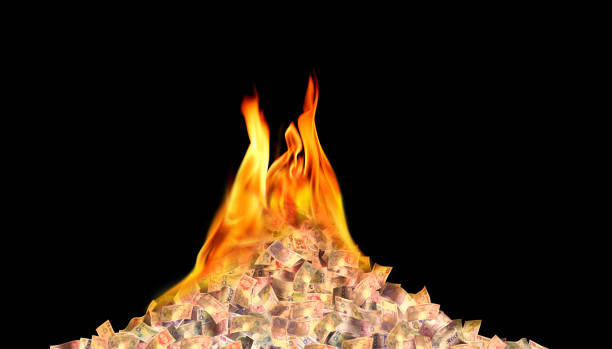 A pile of coins surrounded by fire. Danger of losing savings. Inflation, confiscation of savings. Overdue money system. Financial danger, inflation, or the threat of savings loss.