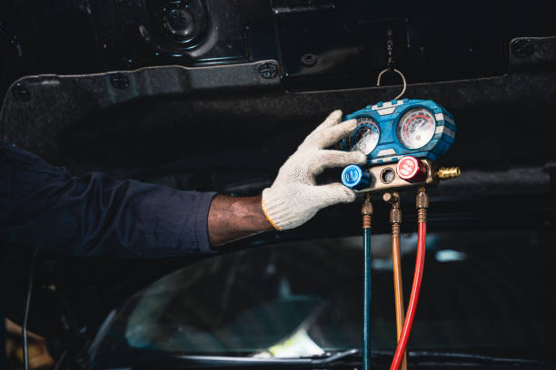 istock Mechanic is fixing the car air conditioner. 1414818812