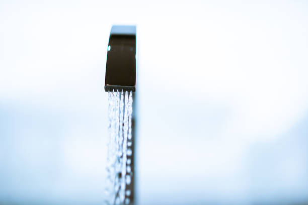 Water flowing from the luxury water tap in wash room with copyspace