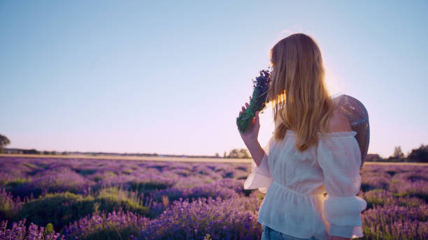 istock Looking for inner peace. Woman picking lavender flowers 1414822930