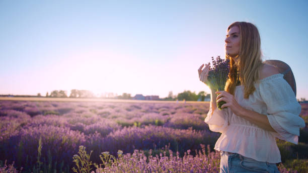 istock Looking for inner peace. Woman picking lavender flowers 1414822955