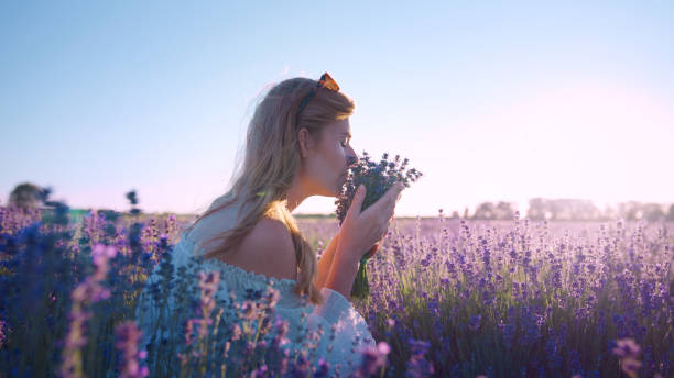 istock Looking for inner peace. Woman picking lavender and smelling flowers 1414823016