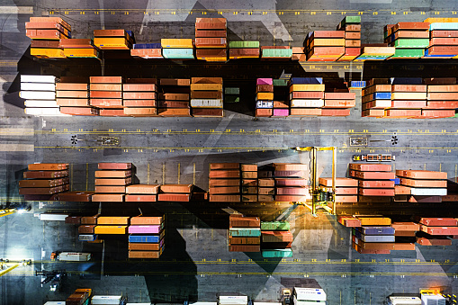 Aerial drone view of containers awaiting shipment via rail/ship at a container port.