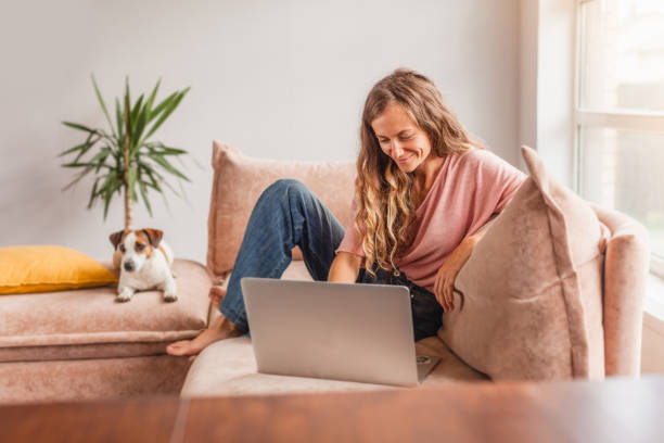 istock Cheerful woman using silver laptop 1414823426