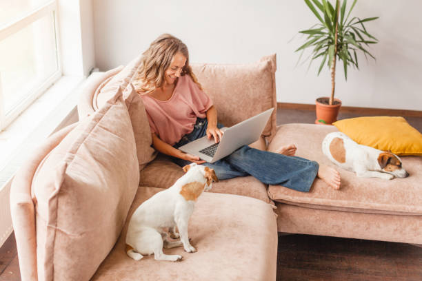 istock Cheerful woman using silver laptop 1414823427