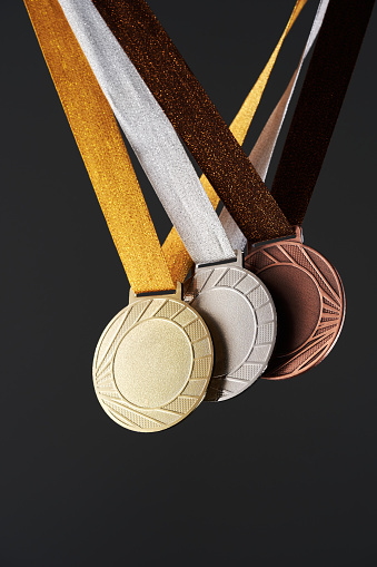 real Gold, silver and bronze medals  isolated on gray background.