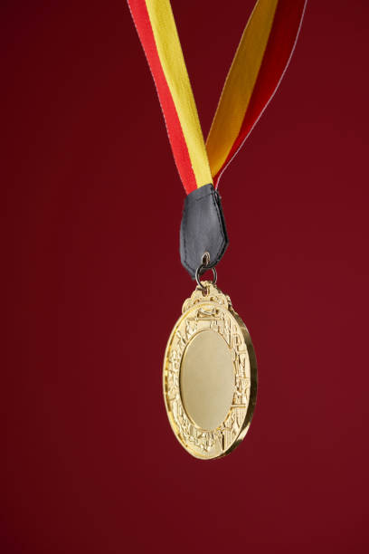 istock gold color medal against red background with copy space 1414825682