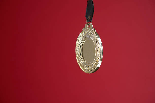 istock gold color medal against red background with copy space 1414825688