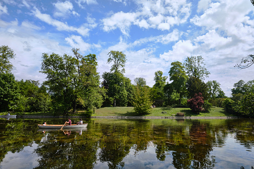 Paris, France - May, 2022: View of lower lake in the Bois de Boulogne and reflections of the nature