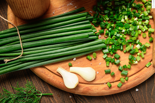 green onion on a dark wooden background, still life, concept of fresh and healthy food
