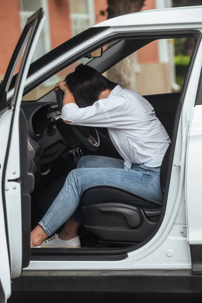 istock female driver driving her car 1414828542