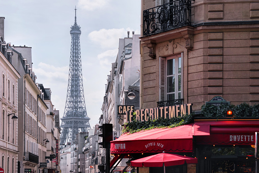 Paris, France - May, 2022: Famous Parisian cafe Le Recrutement, located on 36 Boulevard de la Tour-Maubourg, Eiffel tower in background