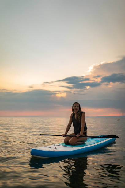 istock Millennial woman relaxing on SUP board in summer time 1414829006