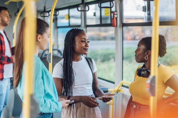 istock Multiracial group of female friends talking while riding in a bus 1414829682