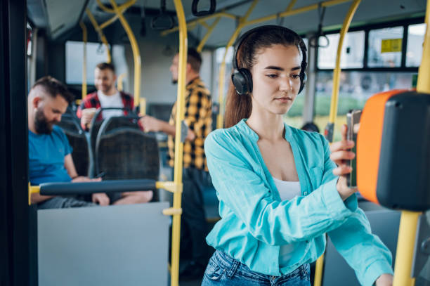 istock Woman paying a bus ticket via smartphone during a ride 1414829701