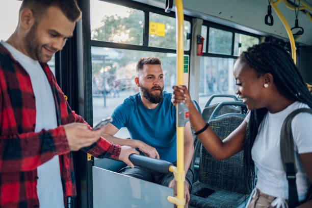 istock Multiracial group of friends talking while riding in a bus 1414829705