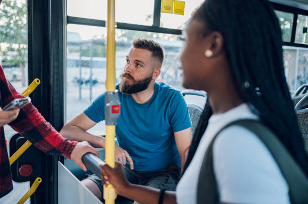 istock Multiracial group of friends talking while riding in a bus 1414829714