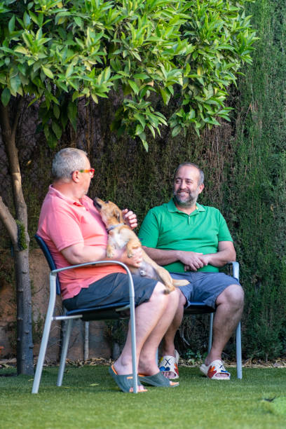 istock Cheerful men chatting on street 1414830134