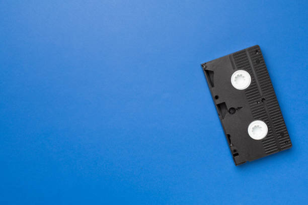 istock Old analog tape VHS cassette on color background, top view 1414830172