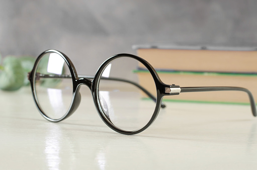Stylish glasses for vision in a black round frame on the table
