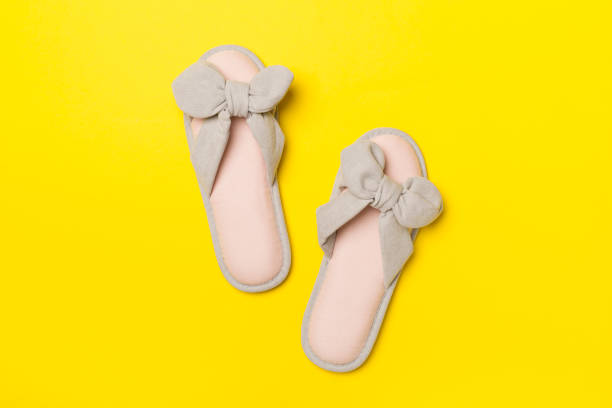 istock Soft pink slippers on color background, top view 1414833203