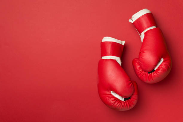 istock Red boxing gloves on color background, top view 1414834402
