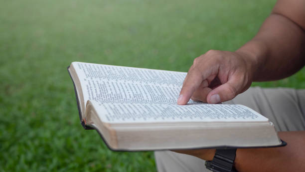 istock Man reading from the holy bible, close up 1414835555