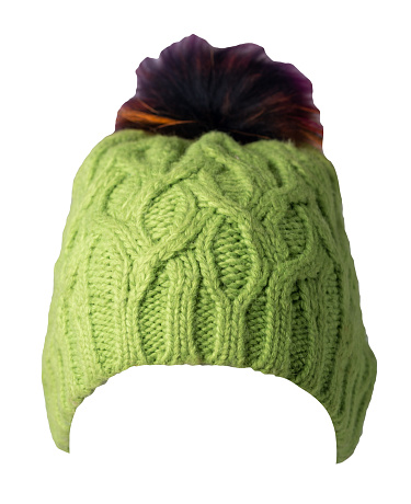 women's green hat knitted with pompon isolated on white background. warm winter accessory