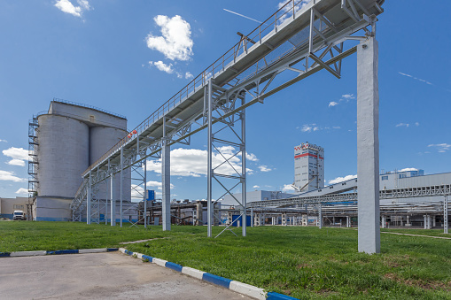 Summer view of big chemical plant. Production of nitrogen fertilizers. Blue sky on the background.