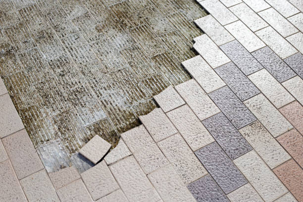 istock Cracked brown tiles on cement floor 1414842254