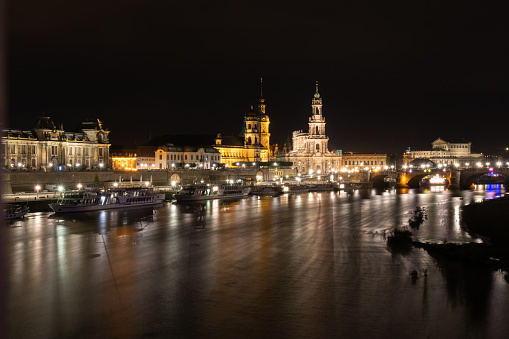 Dresden, Saxon, Germany, July 10, 2022 View along the Elbe river to the illuminated historic buildings at night