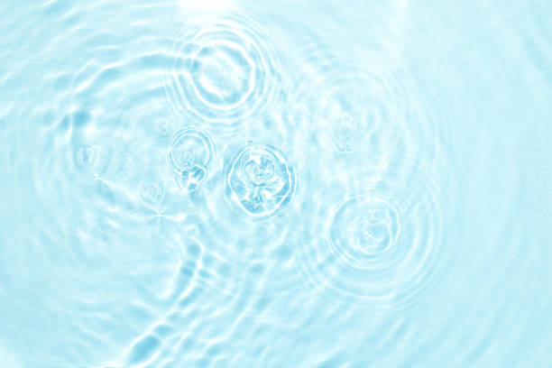 istock Closeup of blue water surface texture with splashes and bubbles 1414845332