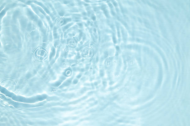 istock Closeup of blue water surface texture with splashes and bubbles 1414845357