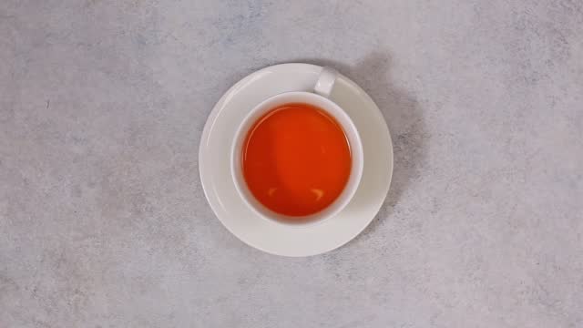 top view of white cup of tea. white stone background,top view