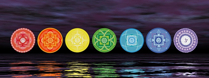 Seven chakra symbols on the horizon line by night - 3D render