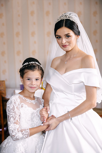 Portrait of Beautiful Bride Posing with her Teenage Daughter