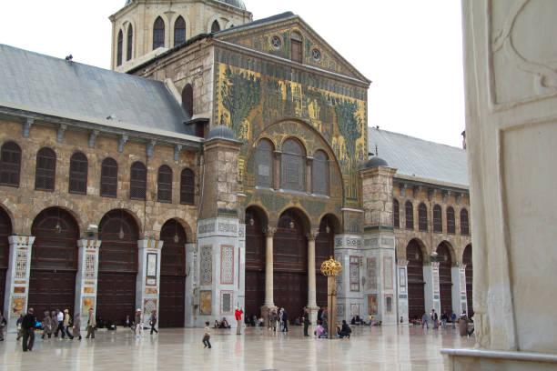 Damascus, Syria - March 20, 2011: People walk in the courtyard of the Umayyad Mosque. Built on the site of a Byzantine church in the 8th century, today it is one of the most beautiful architectural landmarks in Syria.