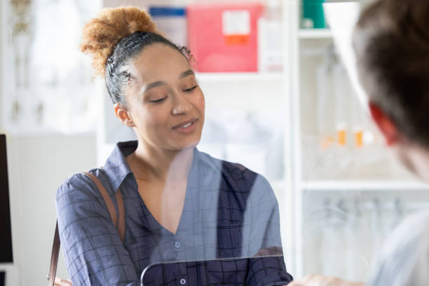 istock Young adult customer purchasing her medication from the pharmacy. 1414851590