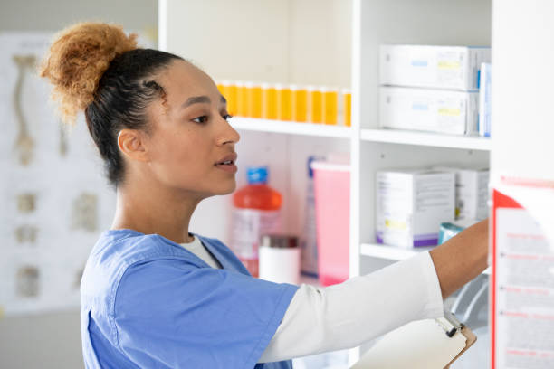istock Young adult pharmacy tech communicating and working with pharmacist. 1414852215