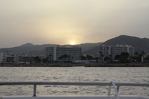 Image of Ibiza town, on a cloudy sunset, as seen from the sea.