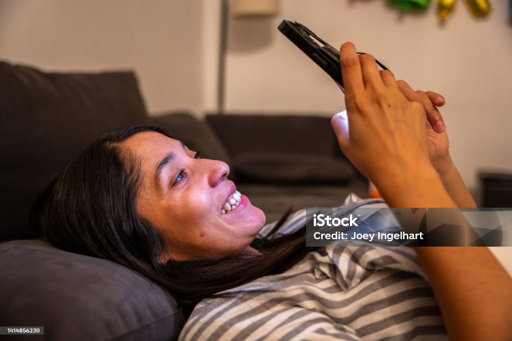Beautiful Women with a Happy Reaction to What She Sees on her Phone 30-34 Years Stock Photo
