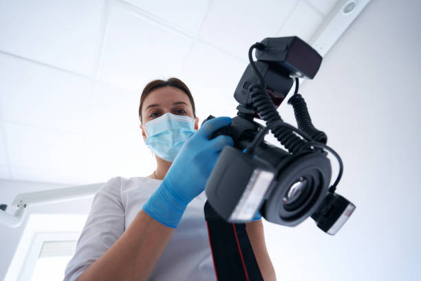 istock Professional stomatologist holding photographic device in her hands 1414856530