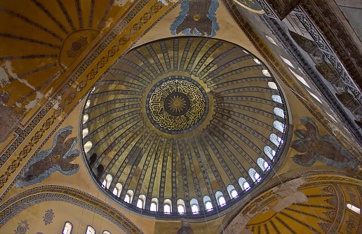 Istanbul,Turkey - August 10, 2022: Turkish and foreign tourists are visiting Hagia Sophia, in the Sultanahmet district of Istanbul. The Hagia Sophia was the main temple of Byzantium then the Muslim mosque and museum but now is Holy Hagia Sophia Grand Mosque (Ayasofya-i Kebir Cami-i Şerifi) This redesignation is controversial, drawing condemnation from the Turkish opposition, UNESCO, the World Council of Churches, the International Association of Byzantine Studies, and many international leaders.