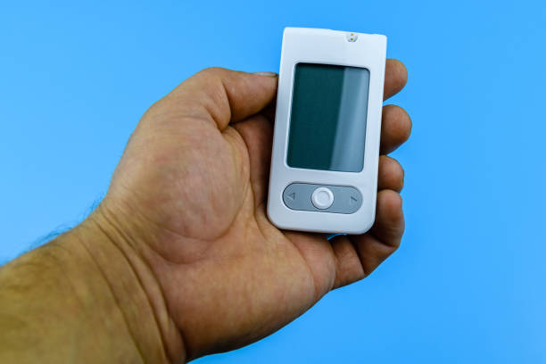 istock Glucometer in human hand. Medical device for the measuring sugar 1414858150