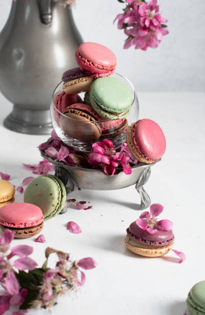 istock spring still life with colored macaroons and pink apple tree flowers in a pewter 1414865031
