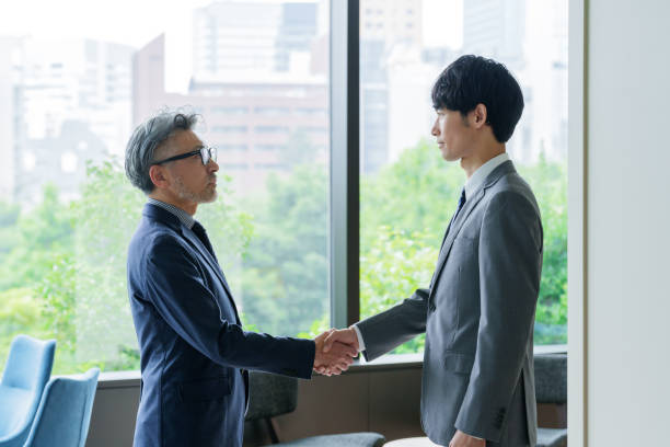 istock asian businessmen handshaking in the office 1414866707