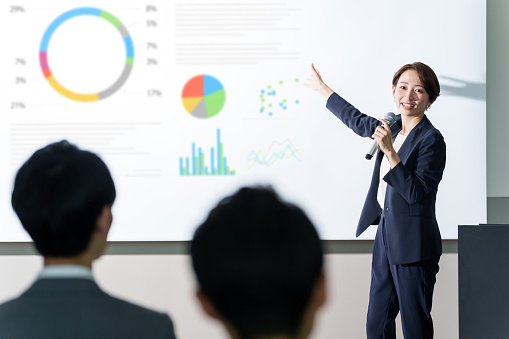 asian businesswoman giving a presentation in a conference room
